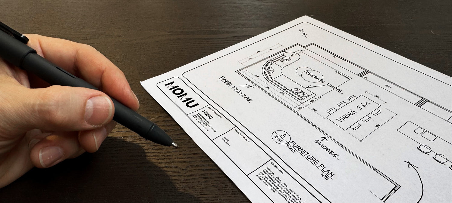 MOMU designer drawing a scaled room layout for custom furniture